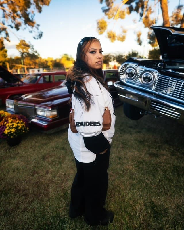 Classic lowrider at car show with custom paint and hydraulic setup