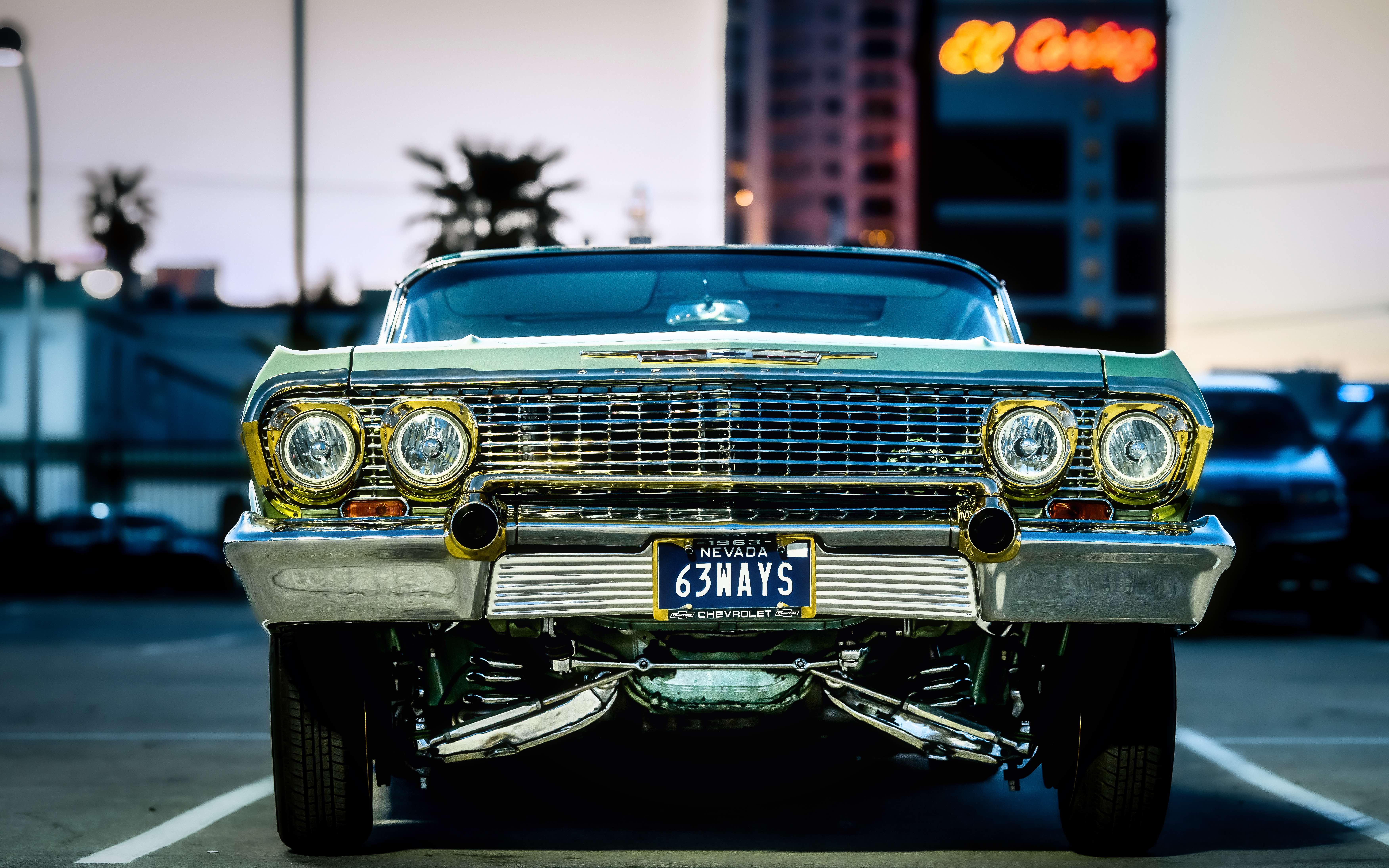 Green 1963 Chevrolet Impala lowrider front view with custom paint and chrome details