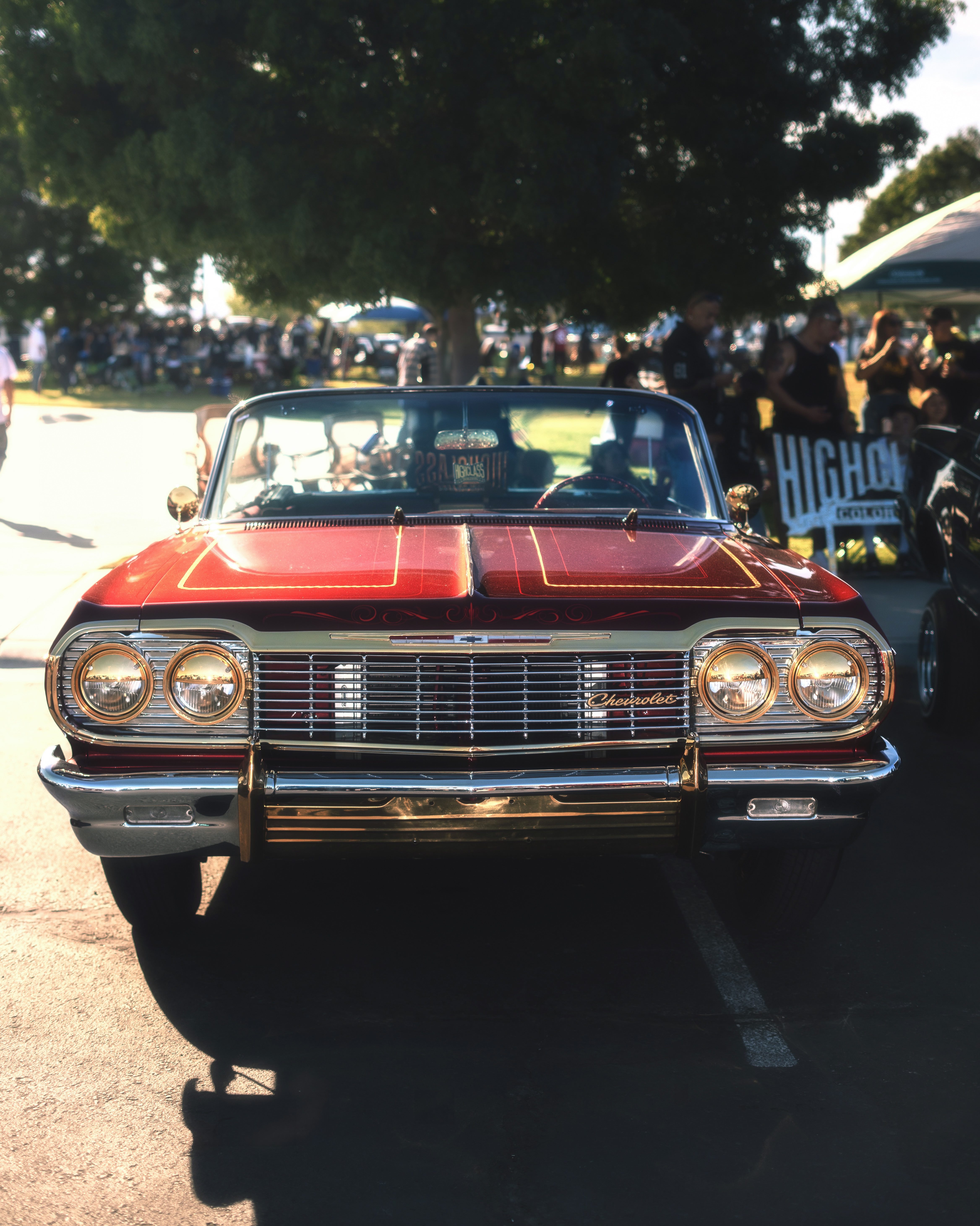 Candy red Chevrolet Impala lowrider front view with chrome grille and custom paint